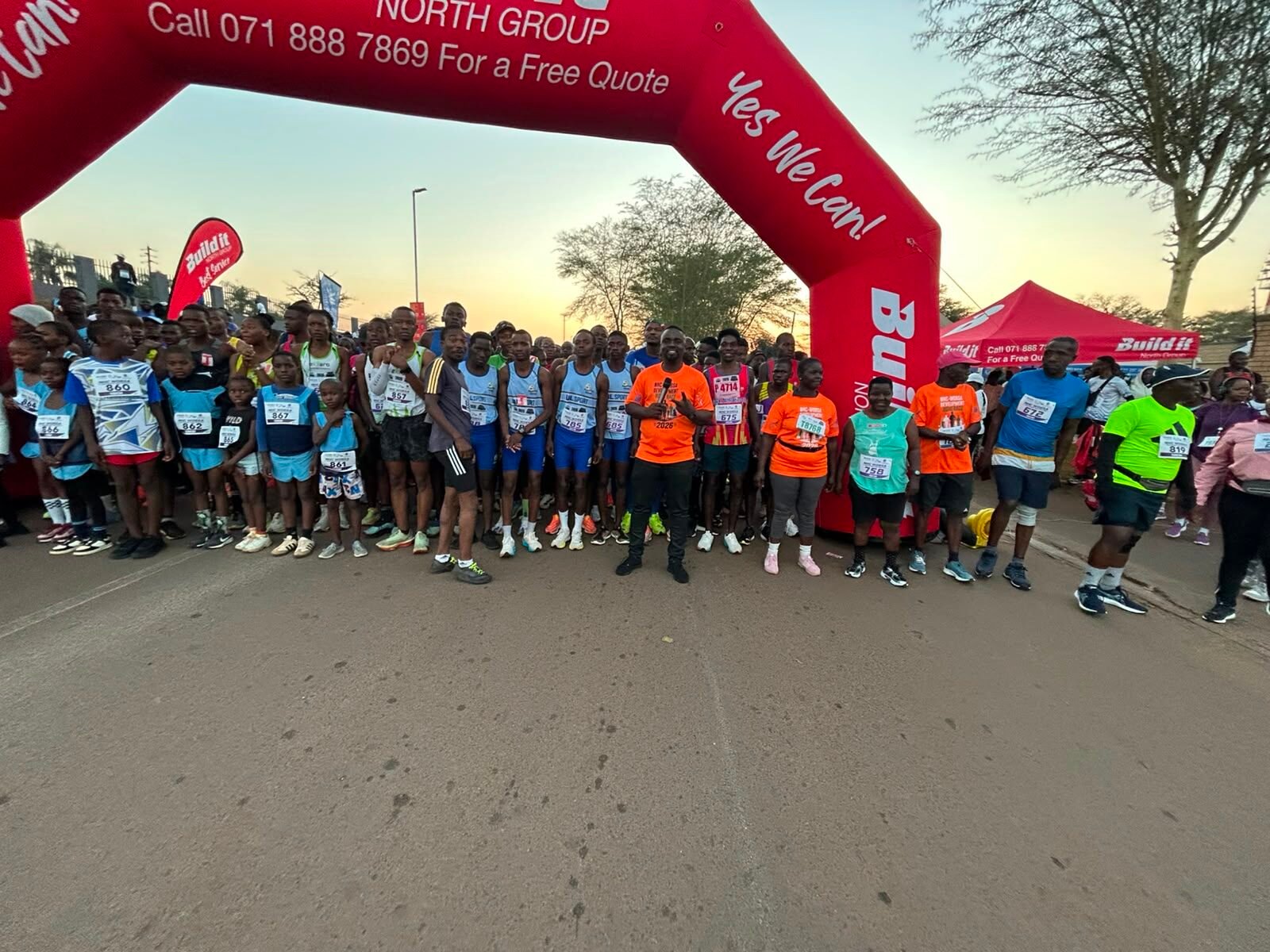 Runners gathered at the start arch at sunrise