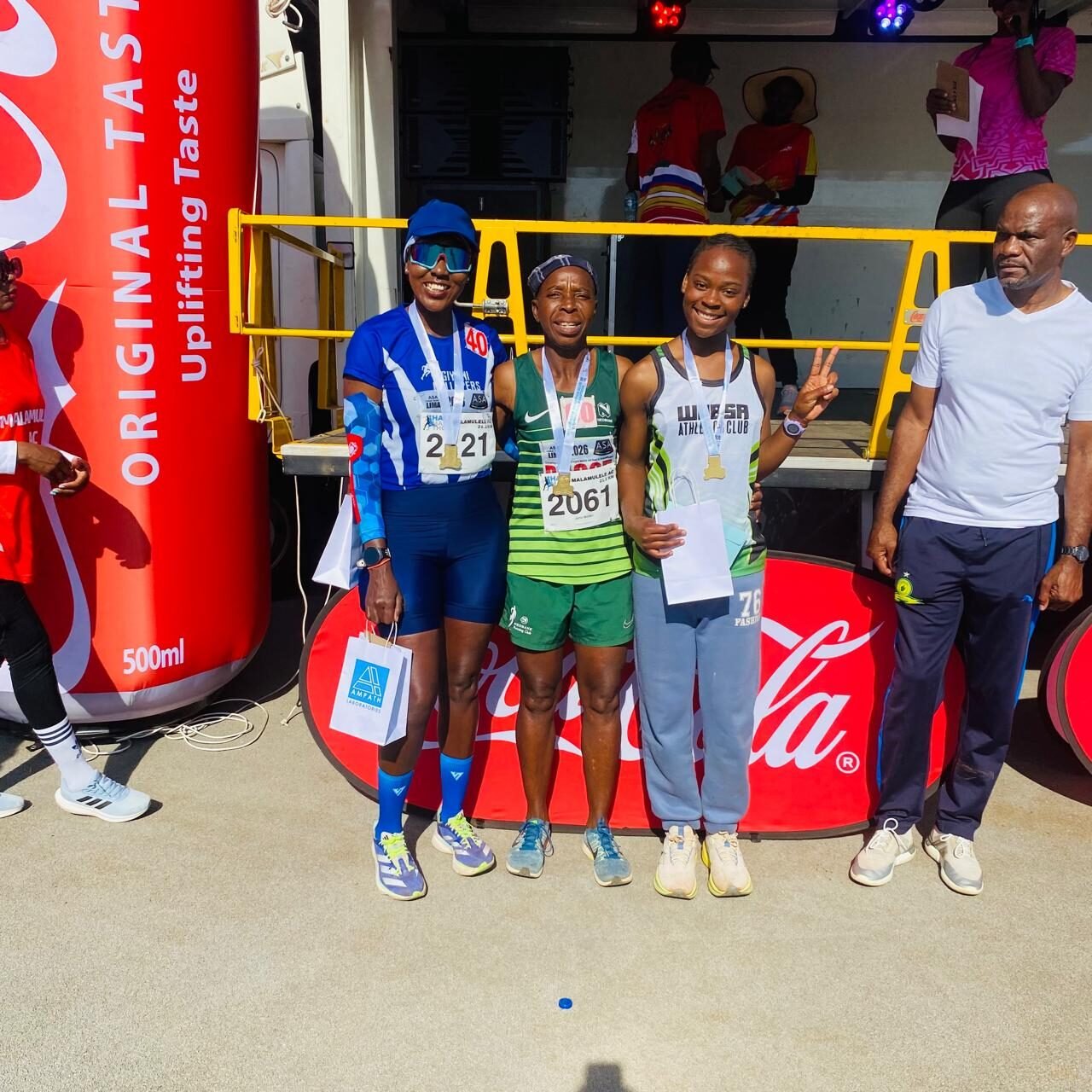 Three women medallists posing together after the Malamulele half marathon